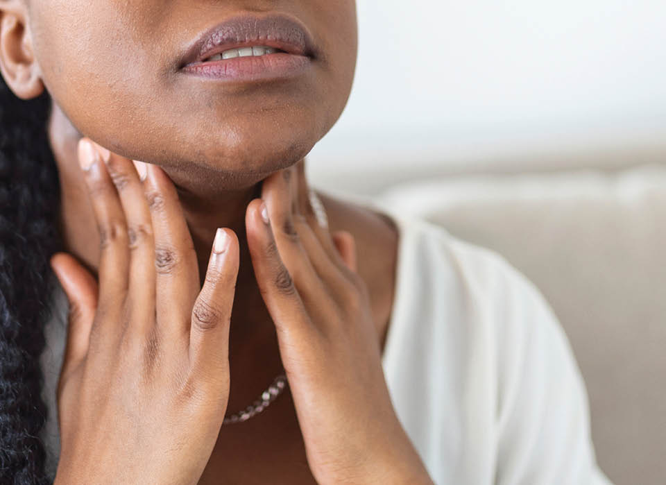 woman-with-thyroid-problems-holding-her-neck